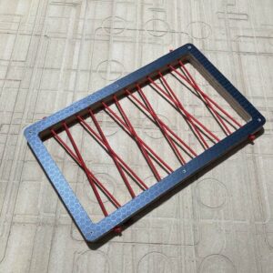 Bungee storage with red bungee cord with a black hexa frame.